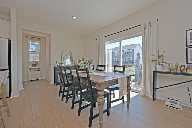 dining area featuring light wood-style flooring, recessed lighting, and baseboards