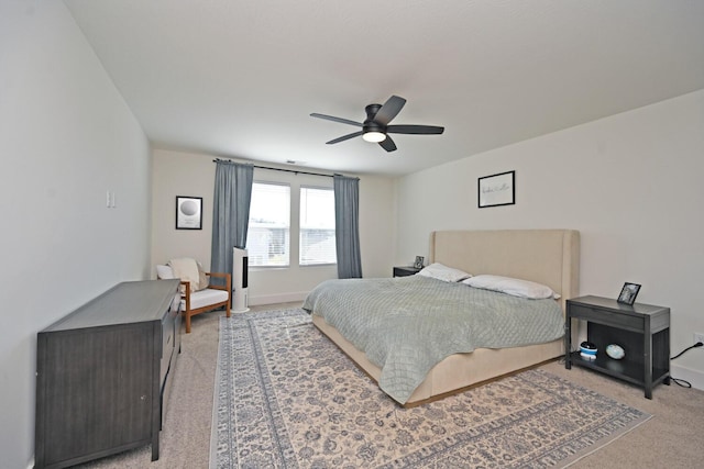 bedroom featuring ceiling fan and light carpet