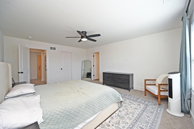 bedroom featuring light carpet, visible vents, baseboards, and a ceiling fan