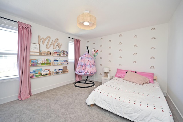 bedroom with baseboards and carpet