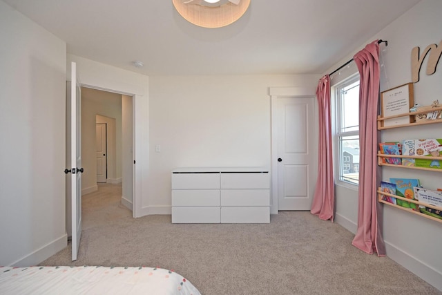 bedroom featuring carpet and baseboards