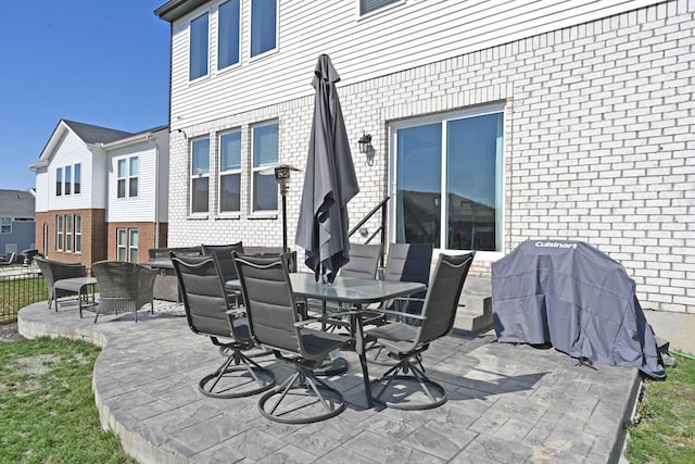 view of patio with area for grilling and outdoor dining area