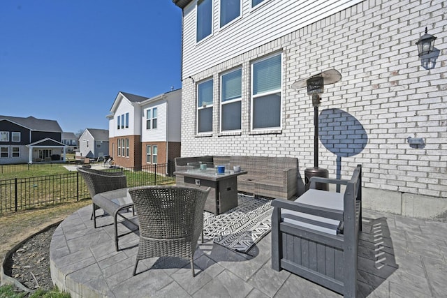 view of patio featuring a residential view, outdoor lounge area, and fence