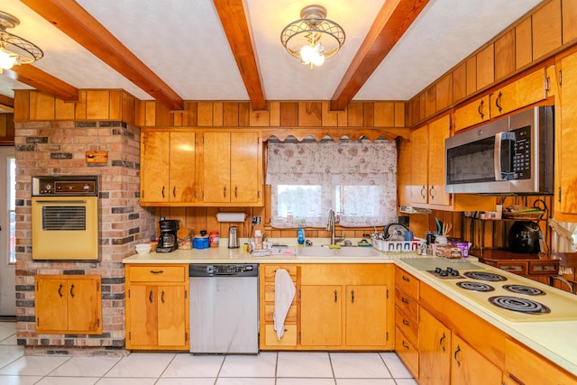 kitchen featuring light tile patterned floors, beam ceiling, a sink, stainless steel appliances, and light countertops