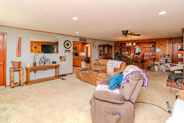 living area with a textured ceiling, recessed lighting, carpet, indoor bar, and ceiling fan