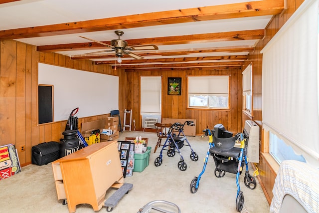 interior space featuring beam ceiling, wooden walls, an AC wall unit, and ceiling fan