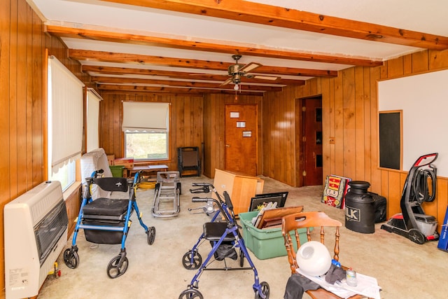 interior space featuring heating unit, wooden walls, and beam ceiling