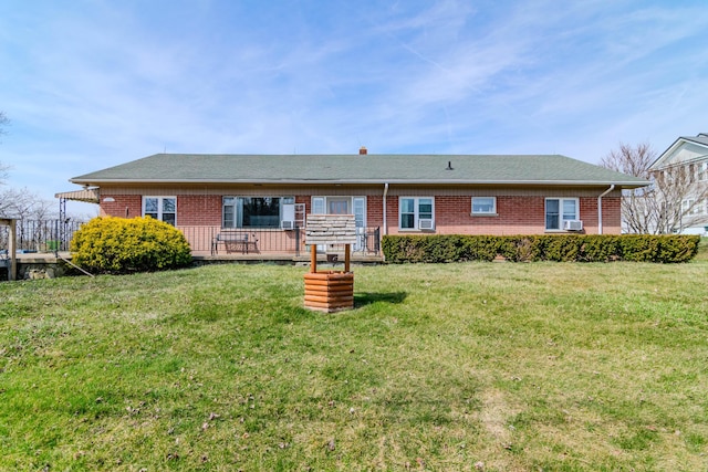 view of front of house featuring a front lawn, brick siding, and a shingled roof