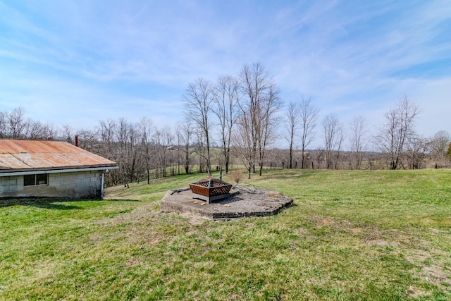 view of yard with a fire pit and a rural view