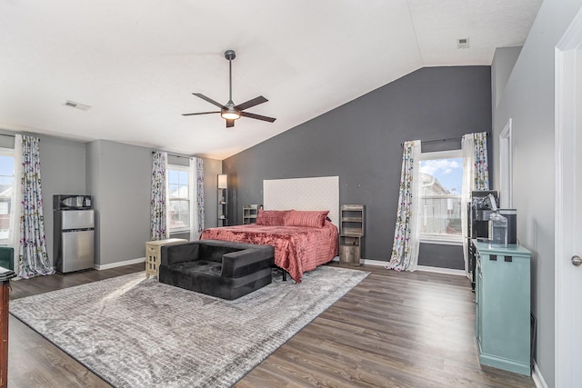 bedroom featuring a ceiling fan, baseboards, lofted ceiling, refrigerator, and dark wood-style flooring