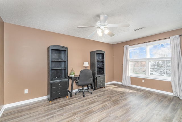 office with light wood-style floors, baseboards, and ceiling fan