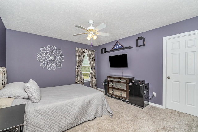 bedroom with baseboards, carpet floors, a textured ceiling, and ceiling fan