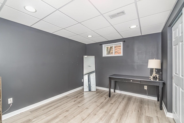 office area featuring visible vents, a drop ceiling, baseboards, and wood finished floors