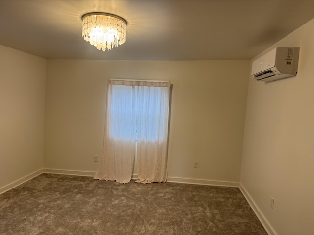 spare room with baseboards, a chandelier, dark carpet, and a wall unit AC