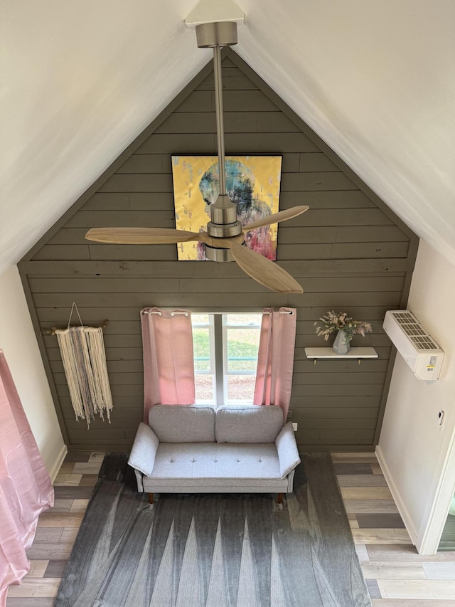 unfurnished bedroom featuring wood walls, lofted ceiling, and wood finished floors