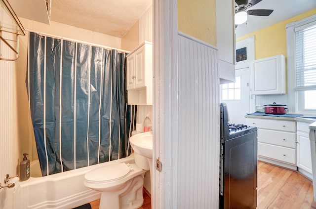 full bath with shower / tub combo, wood finished floors, a textured ceiling, washer / clothes dryer, and a ceiling fan