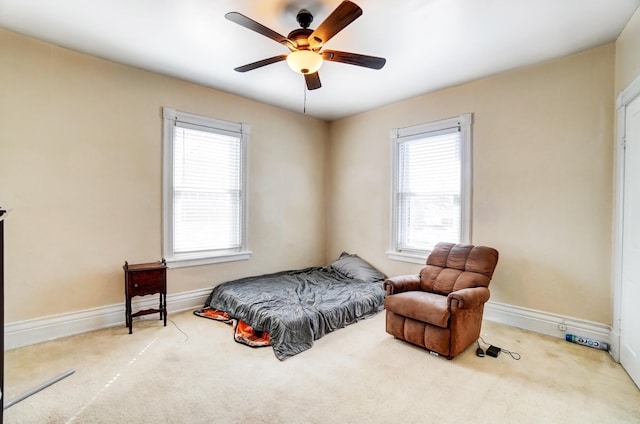 carpeted bedroom featuring baseboards and ceiling fan