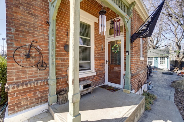 doorway to property with brick siding