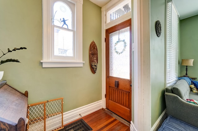 entryway with baseboards and wood finished floors