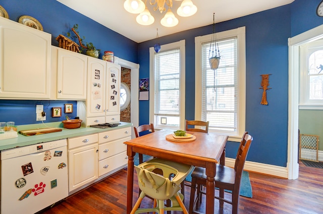 kitchen with dishwasher, dark wood-type flooring, white cabinets, and baseboards