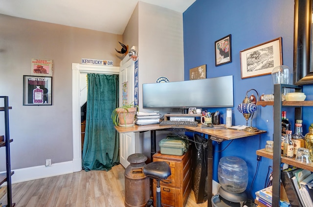 interior space with baseboards and wood finished floors