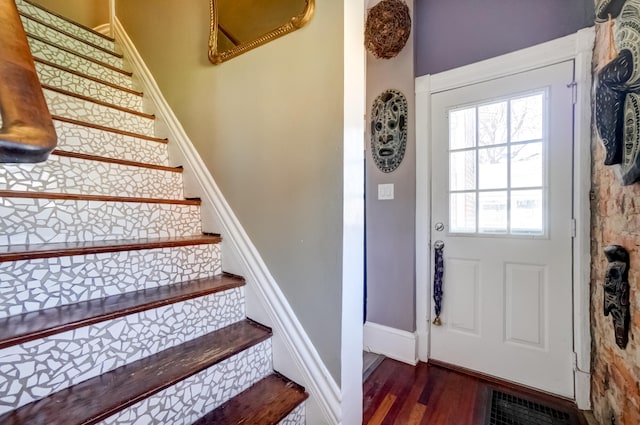 stairs with baseboards and wood finished floors