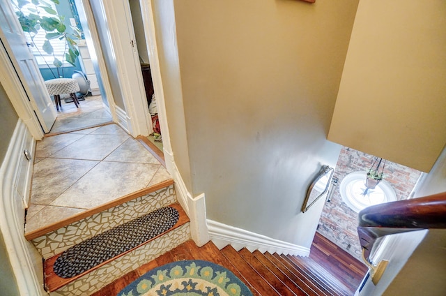 stairs with tile patterned floors and baseboards