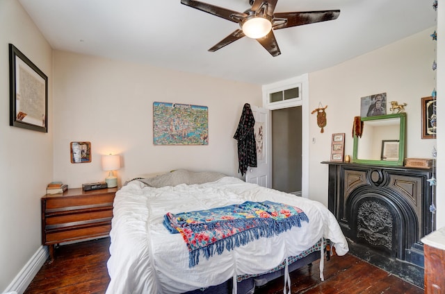 bedroom with baseboards, ceiling fan, and wood finished floors