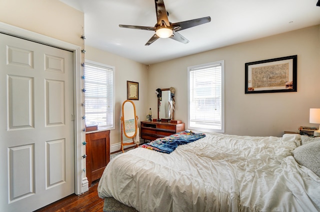 bedroom with dark wood finished floors, baseboards, and ceiling fan