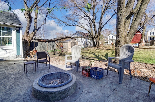 view of patio with an outdoor fire pit and fence