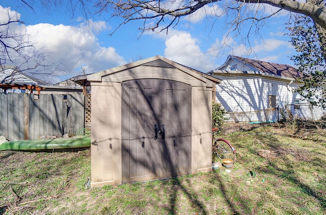 view of shed with fence