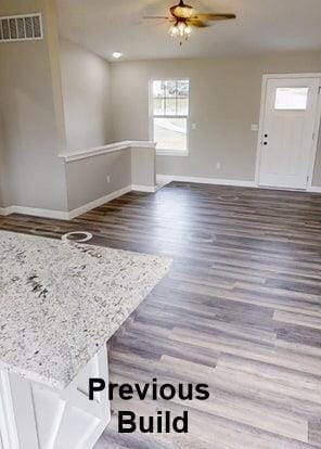 interior space featuring visible vents, baseboards, ceiling fan, and wood finished floors