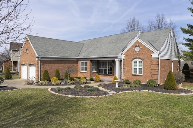 view of front of house with a front yard, a garage, brick siding, and driveway