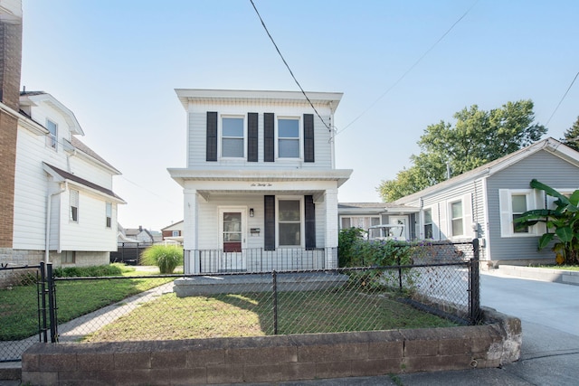 view of front of property featuring a fenced front yard, a porch, driveway, and a front yard