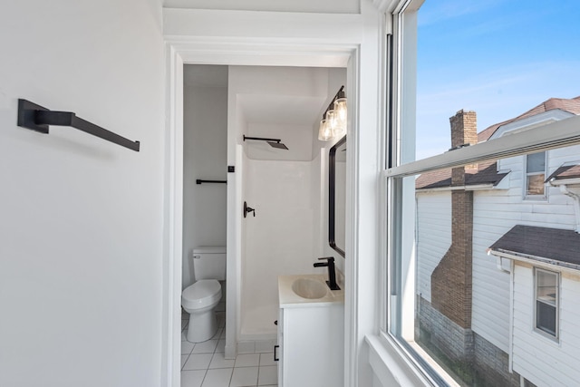 bathroom with tile patterned flooring, toilet, and vanity