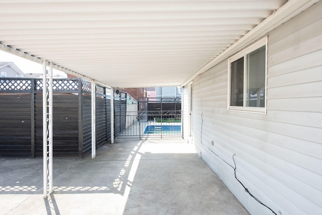 view of patio / terrace featuring an attached carport and fence