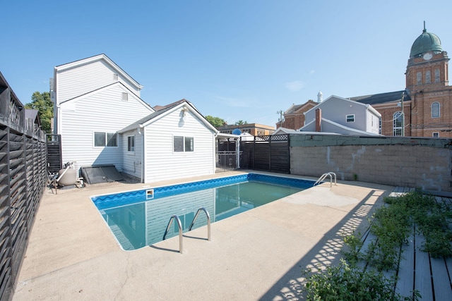 view of swimming pool with a fenced in pool, a fenced backyard, and a patio area