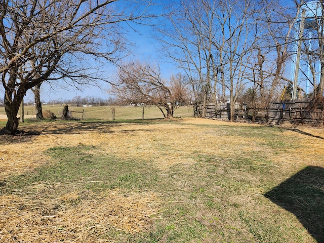 view of yard featuring a rural view and fence