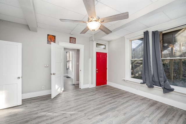 empty room featuring a ceiling fan, baseboards, and wood finished floors