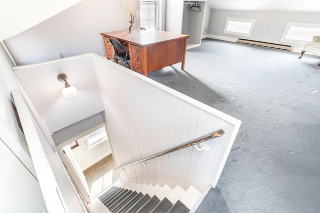 stairs featuring baseboard heating, baseboards, and carpet floors