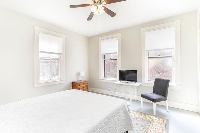 bedroom with baseboards and ceiling fan