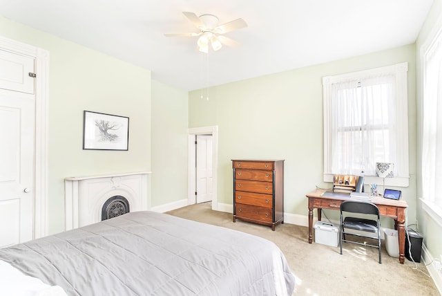 bedroom featuring baseboards, multiple windows, and carpet