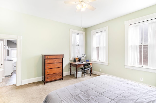 bedroom featuring a ceiling fan, multiple windows, carpet, and baseboards