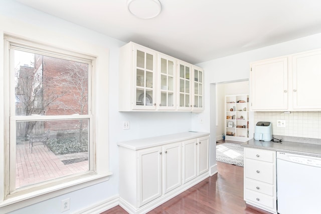 kitchen featuring glass insert cabinets, decorative backsplash, white cabinets, and white dishwasher