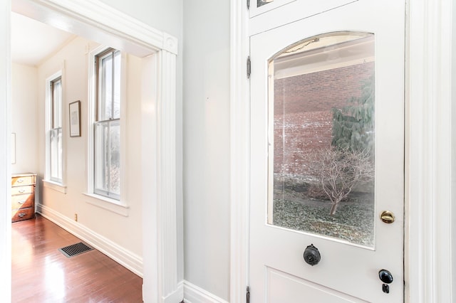 interior space featuring visible vents, baseboards, and wood finished floors