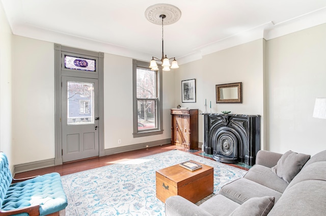 living area featuring wood finished floors, baseboards, and a chandelier