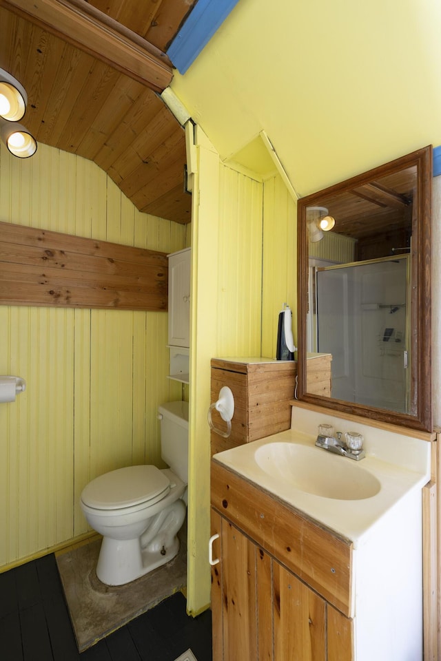 bathroom with vanity, lofted ceiling, a shower stall, wood ceiling, and toilet