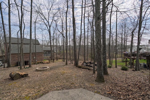 view of yard with a fire pit and a deck