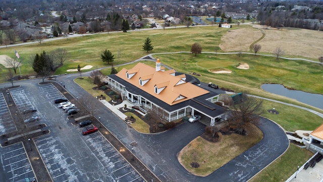 bird's eye view with a water view and view of golf course