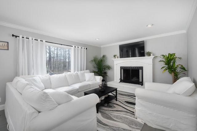 living room with a fireplace with raised hearth and ornamental molding